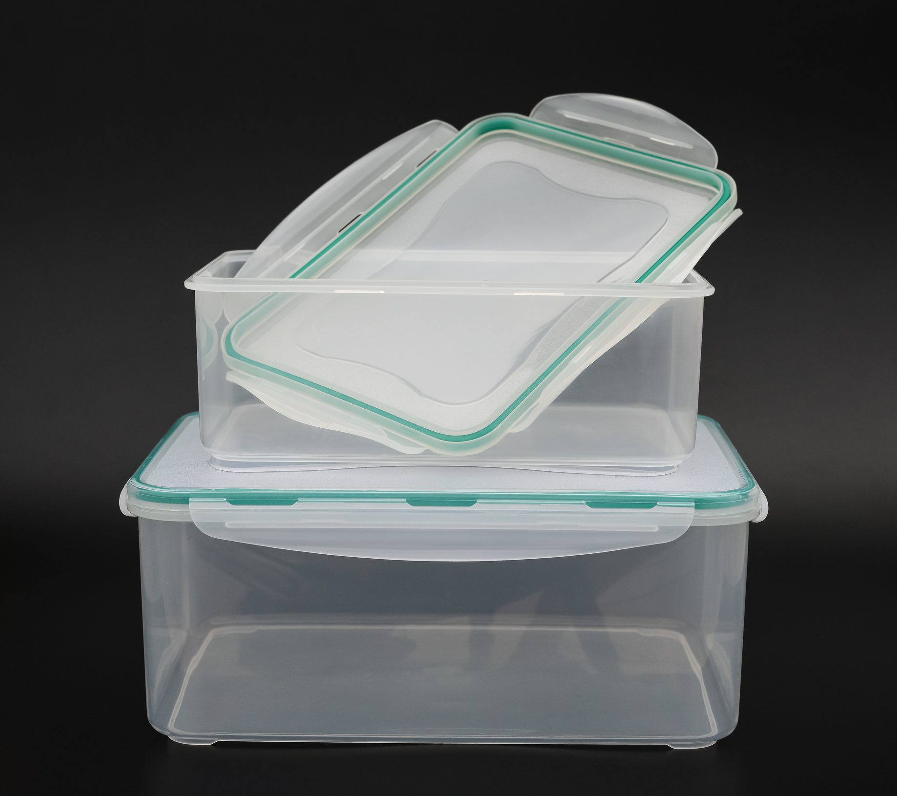 2 clear containers stacked on tops of each other with a black background