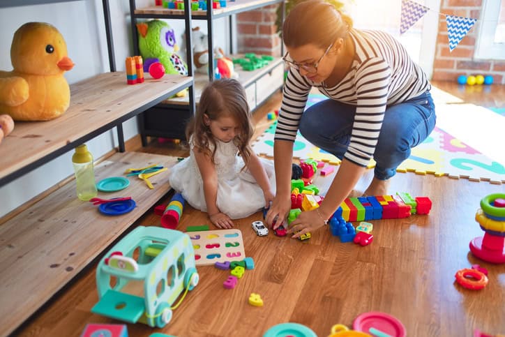 children picking up toys