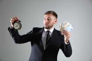 business man holding a clock and money