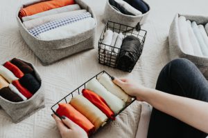 organizing clothes in baskets and bins