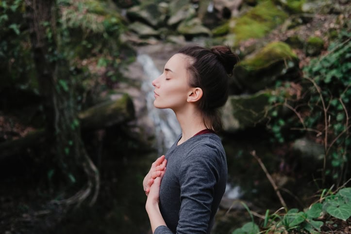 A woman practicing yoga - a form of self-care
