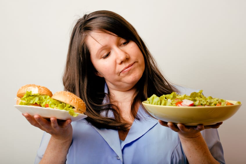 woman chosing salad over burger